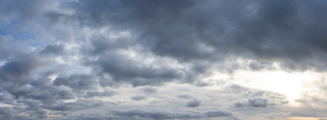 Wall Mural - panoramic cloudscape with dark moody atmospheric clouds