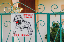 Beware Of The Pit Bull Dog Sign In English And Greek