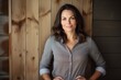 © CogniLens - Portrait of a content woman in her 40s donning a classy polo shirt against a rustic wooden wall. AI Generation