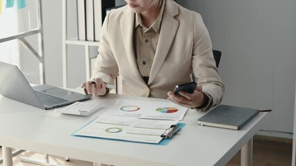 Wall Mural - Asian woman sitting in the office, businesswoman managing a startup company, planning marketing and finding ways to increase profits, managing sales growth, strategizing the company.