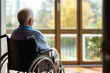 © Adin - Back view Lonely sad elderly person in wheelchair in home nursing looking out window