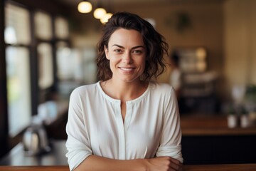 Canvas Print - Portrait of a glad woman in her 30s wearing a simple cotton shirt against a serene coffee shop background. AI Generation