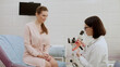 © wedmoments.stock - A gynecologist explains female diseases to a patient using a plastic model of the uterus and ovaries in a modern gynecological clinic. Prevention, preparation for medical examination, pregnancy.