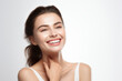 © Jasmina - Portrait of a young smiling woman touching her flawless glowy skin on soft white background, skincare concept