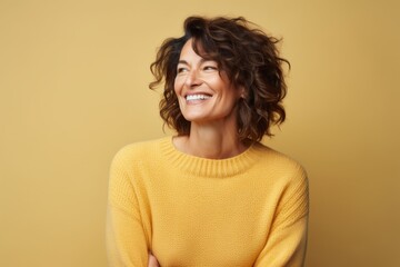 Wall Mural - Portrait of a joyful woman in her 40s dressed in a warm wool sweater against a pastel or soft colors background. AI Generation