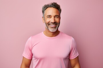 Portrait of a happy man in his 40s wearing a moisture-wicking running shirt against a pastel or soft colors background. AI Generation