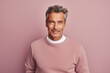 © CogniLens - Portrait of a jovial man in his 50s wearing a cozy sweater against a pastel or soft colors background. AI Generation