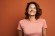 Portrait of a grinning woman in her 40s sporting a vintage band t-shirt against a solid color backdrop. AI Generation