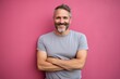 © CogniLens - Portrait of a happy man in his 40s sporting a vintage band t-shirt against a solid pastel color wall. AI Generation