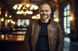 © CogniLens - Portrait of a smiling man in his 40s wearing a trendy bomber jacket against a scandinavian-style interior background. AI Generation