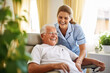 © pkproject - Compassionate Home Care, Joyful Nurse Attending to a Senior Gentleman Comfortably