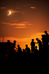 group of friends looking out into the evening sky in search of the new crescent moon the beginning of Ramadan