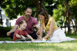 © atitaph - Happy family day, father, mother, son, Caucasian enjoying watercolor painting and picnic in nature.