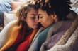 Made with generative AI portrait young female couple wrapped in fluffy blanket in love