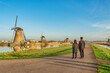 © Noppasinw - Dutch Windmill landscape at Kinderdijk Village Netherlands with love couple walking