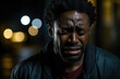 © Anna - Tearful African man expressing deep sorrow and grief.