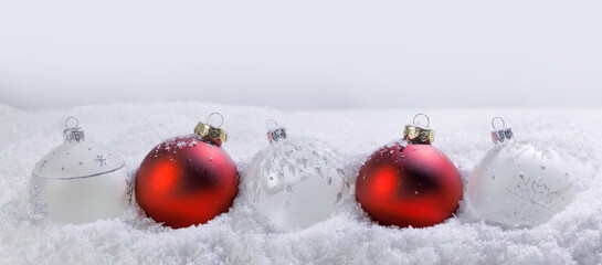 Wall Mural - Christmas red and white baubles in snow