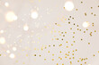 © magic_cinema - Festive gold background. Shining stars confetti and fairy lights on beige and Set Sail Shampagne background. Christmas. Wedding. Birthday. Flat lay, top view, copy space