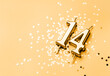 14 years celebration festive background made with golden candle in the form of number Fourteen lying on sparkles. Universal holiday banner with copy space.