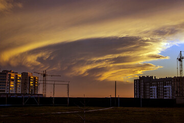 Wall Mural - Swirling clouds in the sky at sunset