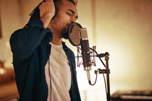 Young Man Singing Into A Music Studio Microphone