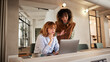 © Flamingo Images - Young businesswomen working on a laptop
