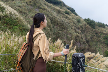 Wall Mural - Woman hiking in mountain travel adventure