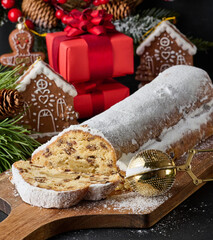 Canvas Print - Christmas pastries stollen sprinkled with powdered sugar on the table, festive dessert