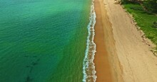 .aerial View Sea Waves Seamless Loop On The White Sand Beach. .Wave After Wave Swept Towards The Shore On The Long White Beach..green Sea, White Bubble Waves,and Clear Sand Landscape. Paradise Beach.