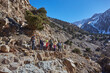 A group of tourists trekking through the stunning Atlas Mountains in Morocco