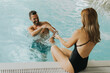 © BGStock72 - Young couple having fun in the indoor swimming pool