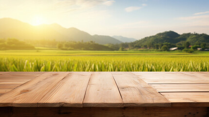 Empty wood table and blurred rice field and mountain landscape at morning. Empty wooden table with rice field and sunshine