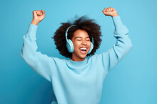 Happy Woman With Headphones Dancing Isolated Over Blue Background.