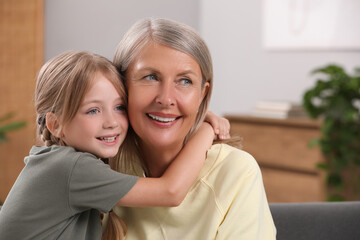 Sticker - Happy grandmother with her granddaughter at home, space for text