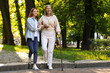 © New Africa - Senior lady with walking cane and young woman in park. Space for text