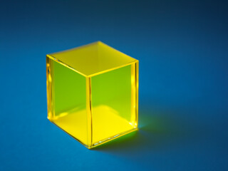 gold cube isolated on blue background.