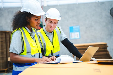 Professional worker in safety uniform hard hat, supervisor inspector packaging stock order at factory warehouse, piles of stacking paper manufacture, recycling production industry.