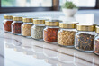 Close up of glass container of spices on reflection marble table in background of modern kitchen. Cooking concept of powder and seasoning.