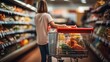 © sirisakboakaew - Woman doing grocery shopping at the supermarket.