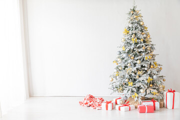 Wall Mural - christmas tree with gifts and toys decorated with christmas garland