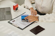 © AnnaStills - Close-up of woman putting stamp and approving documents for visa
