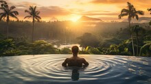 Traveler Man On Vacation In Swimming Pool At Spa Resort With Tropical Nature View At Sunrise