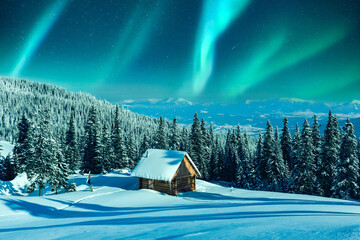 Wall Mural - a mountainous winter vista with a rustic cabin and snow-laden pine trees on a meadow. aurora boreali
