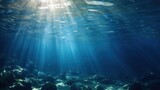 Fototapeta Do akwarium - blue gentle waves The ocean surface is visible from underwater rays of sunlight penetrating through it.