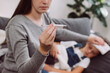 Selective focus of young mother treating sick daughter kid suffering from flu and fever, holding thermometer, checking high body temperature, applying cold compress on forehead. Childcare concept