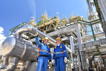 group of workers professional equipment in a petroleum refinery - modern buildings and industrial facilities for the production of fuel and gas