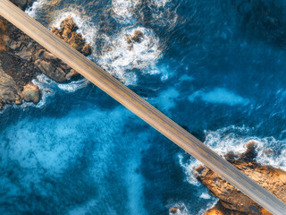 Wall Mural - aerial view of road, sea with waves and stones at sunset in lofoten islands, norway. landscape with 