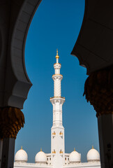 Minaret tower photographed through the arc of Sheikh Zayed Grand Mosque. Abu Dhabi, UAE - 8 February, 2020
