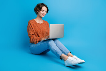 Poster - Full length photo of lovely young lady apple macbook samsung work netbook wear trendy brown garment isolated on blue color background