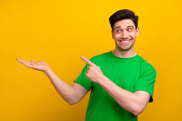 Poster - Photo of happy man in green t shirt showing new terms youtube premium subscription student discount isolated on yellow color background